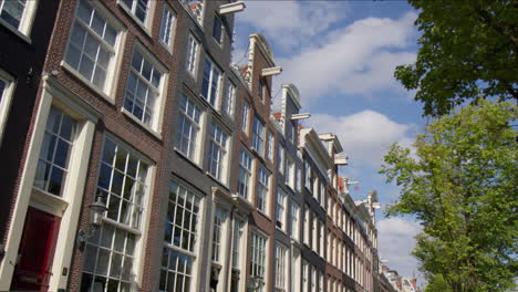 typical facade with multiple windows in streetscape of amsterdam, netherlands. pov shot
