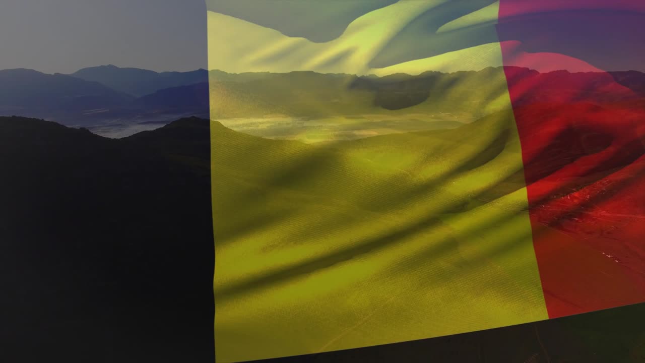 Light breeze starting tricolor fabric waving over valley, revealing fog through yellow translucency