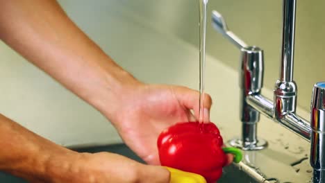 hands washing peppers