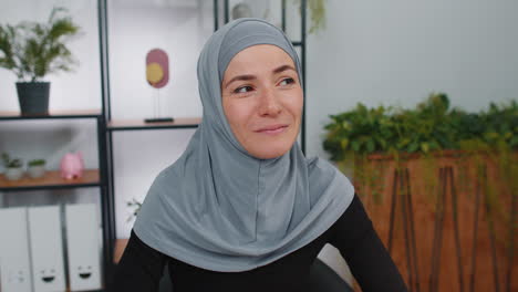 Portrait-of-happy-calm-young-muslim-business-woman-wearing-hijab-smiling-friendly-dreaming-satisfied