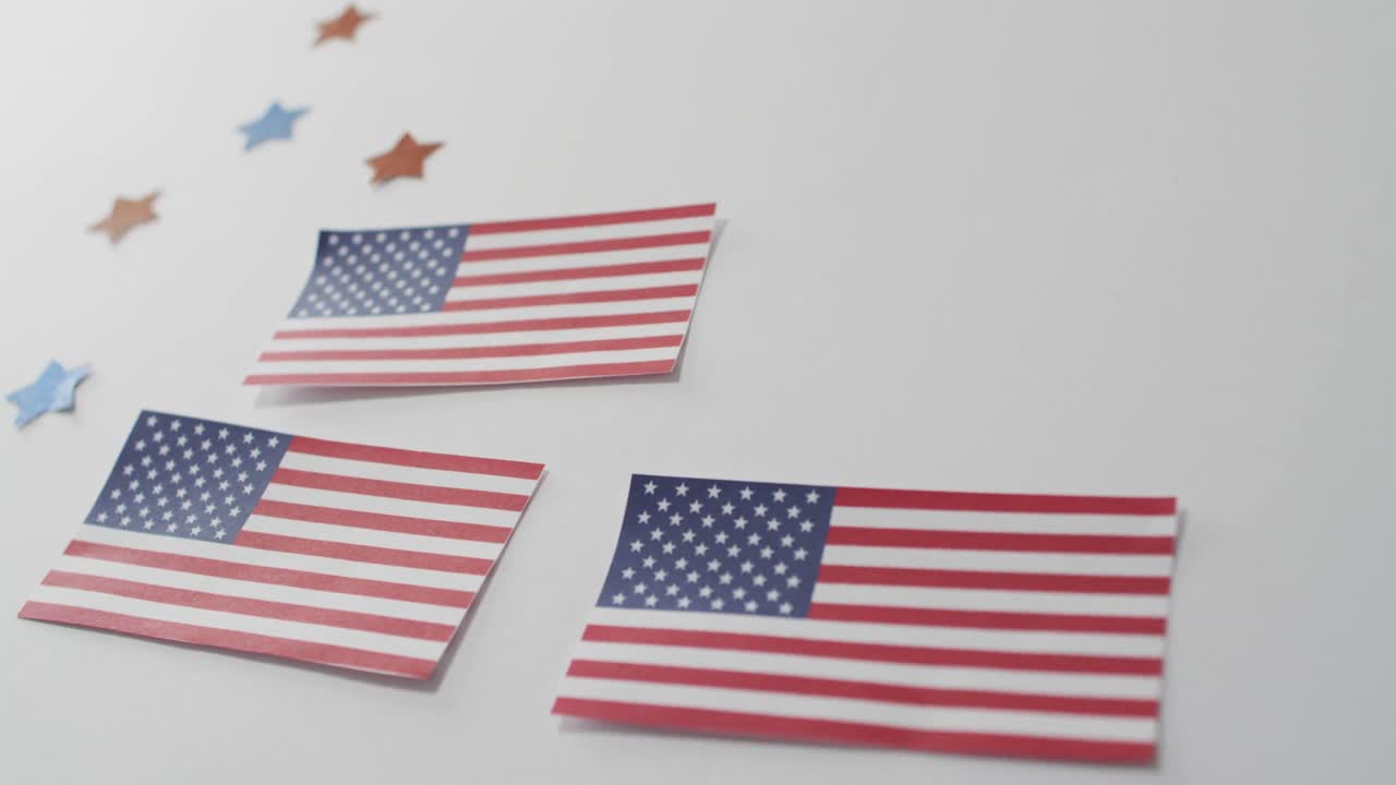 American flags with red and blue stars lying on white background