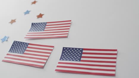 American-flags-with-red-and-blue-stars-lying-on-white-background