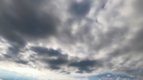 Dark grey clouds accumulating in the atmosphere. Cumulus clouds covering the sky. Timelapse.