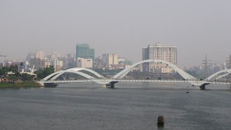 modern bridge over a river in a cityscape