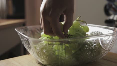 Toronto,-Canada---Hand-Picking-Fresh-Green-Grapes-In-A-Square-Crystal-Bowl---Closeup-Shot