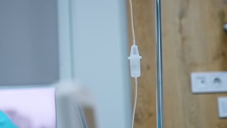 female nurse looks at the drop counter with dripping medicines. medical equipment working in the hospital ward.