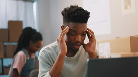 Headache,-stress-and-black-man-on-laptop-in-home