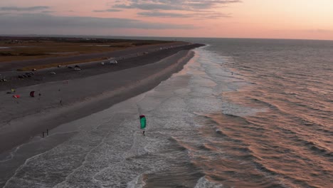 kitesurfers near the beach of domburg during sunset