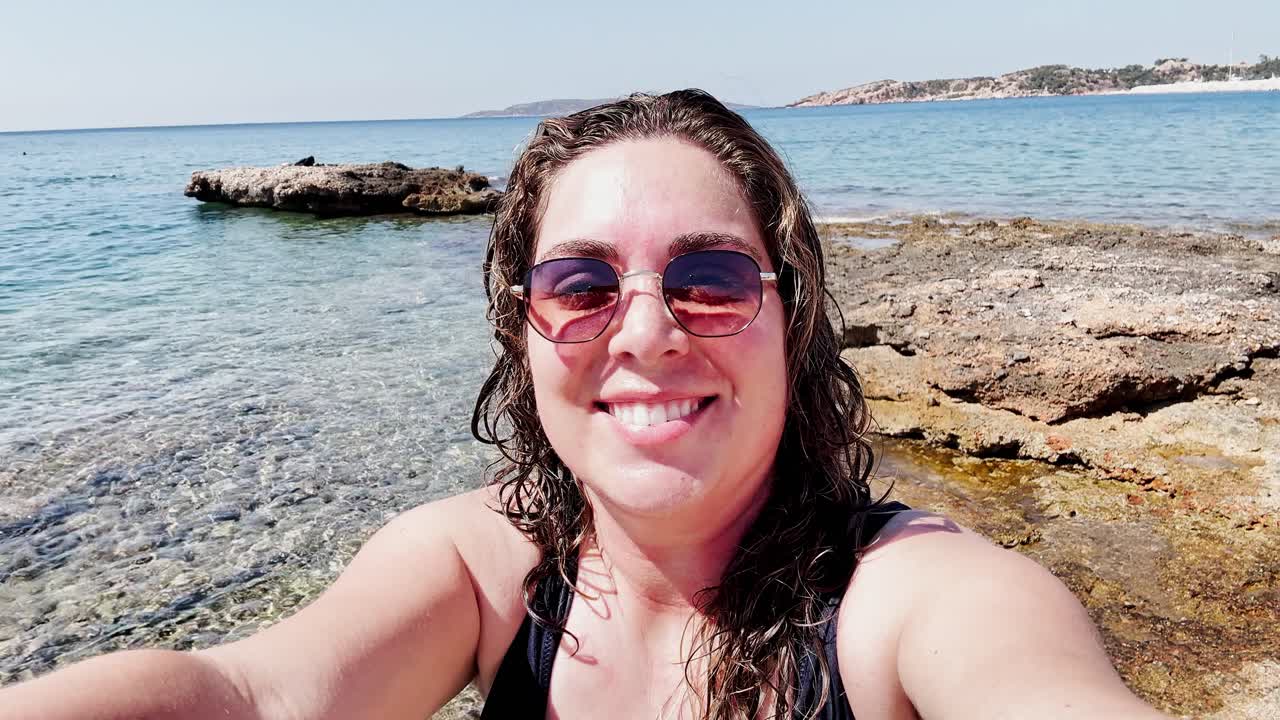Happy Woman Vlogging Her Sunny Beach Day at Vouliagmeni