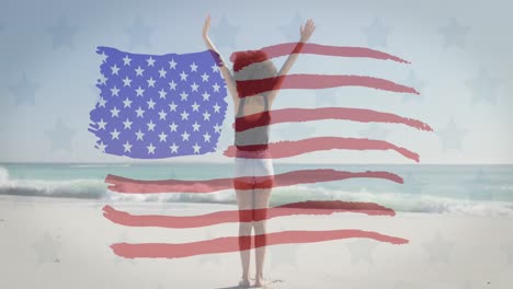 Bandera-Americana-Ondeando-Sobre-Una-Mujer-Afroamericana-De-Pie-Con-Los-Brazos-Abiertos-En-La-Playa