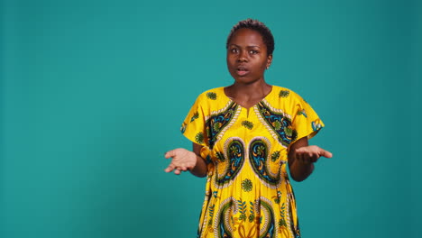 Uncertain-woman-acting-confused-and-raising-shoulders-in-studio