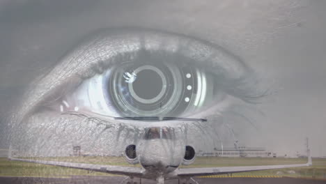 close-up of eye with digital interface animation over airplane on runway