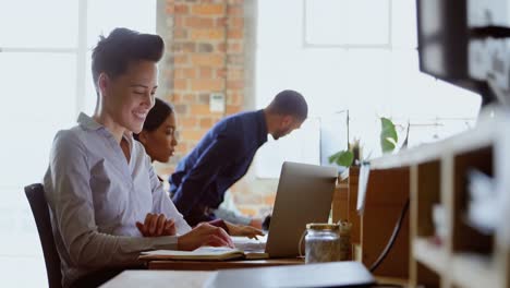 executive using laptop at desk in office 4k