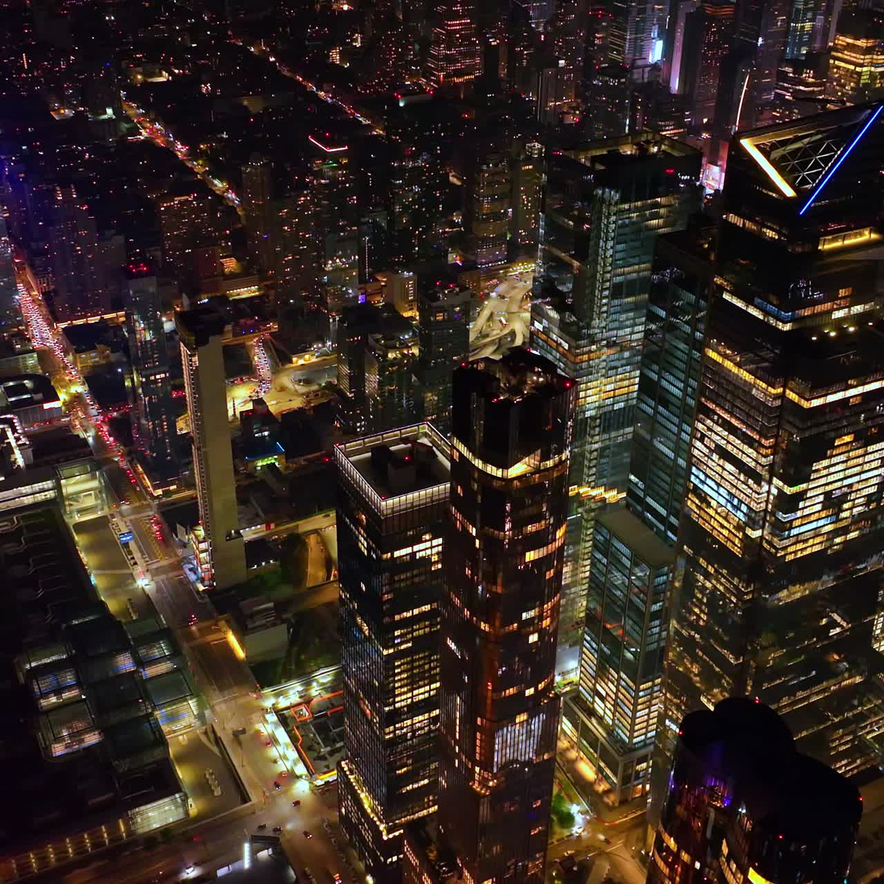 Full of light New York at night time. Drone footage over the tops of famous skyscrapers and light streets