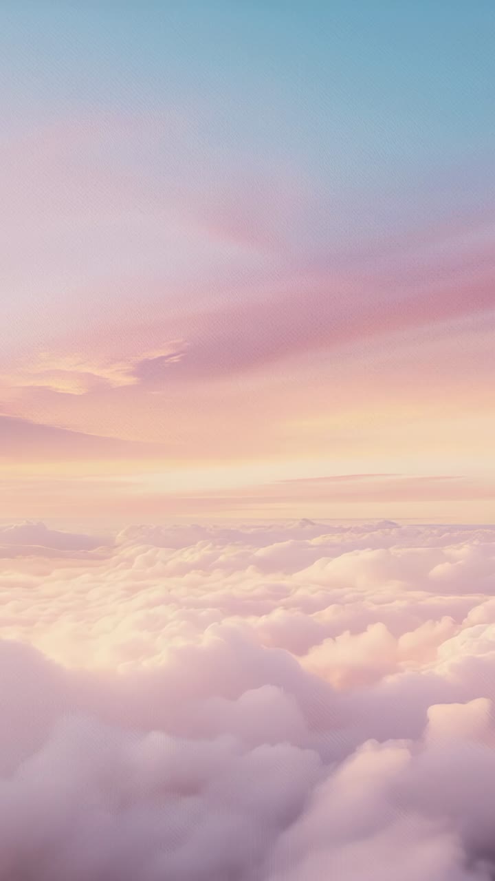 Vertical video: Emerging sunrise light illuminating clouds drifting in aerial view, with pastel hue