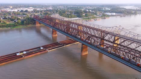 aerial of river barge under three steel bridges over the mississippi river with memphis tennessee background 2