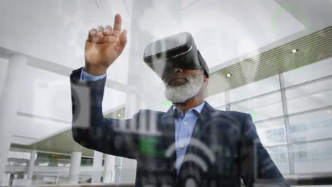 animation of digital icons over african american businessman wearing vr headset at office