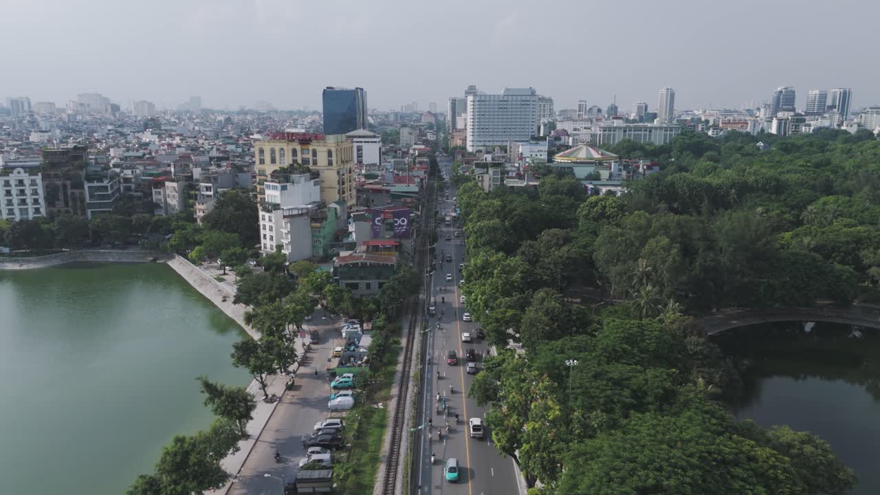 Drone aerial of Le Duan Street in Hanoi, Vietnam, revealing Uncle Ho and Ton Monument and the cityscape, showcasing urban layout, historical landmarks, and Hanoi’s vibrant atmosphere