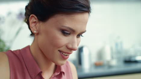 Business-woman-working-on-laptop-at-home.-Smiling-girl-drinking-tea-in-kitchen.