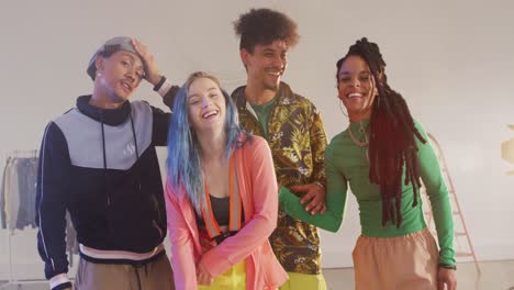 Portrait-of-happy-diverse-male-and-female-dancers-posing-in-dance-studio,-slow-motion