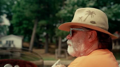 Bearded-man-driving-boat-on-the-lake