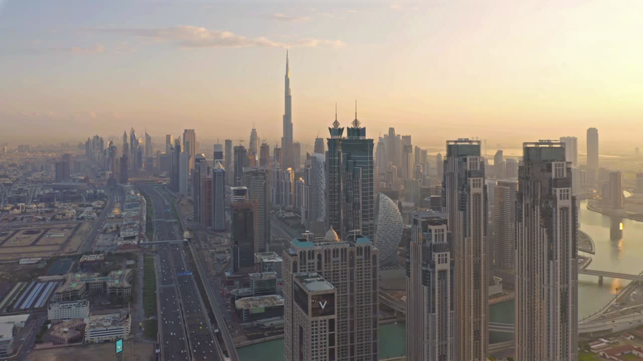 Aerial view of Dubai Downtown skyline, highway roads or street in United Arab Emirates or UAE. Financial district and business area in smart urban city. Skyscraper and high-rise buildings at sunset.