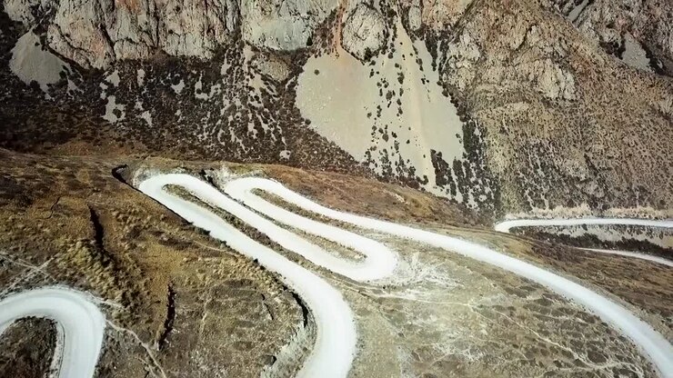 Incredible mountain curvy mountain road through the middle of Kyrgyzstan on an epic road trip around central asia