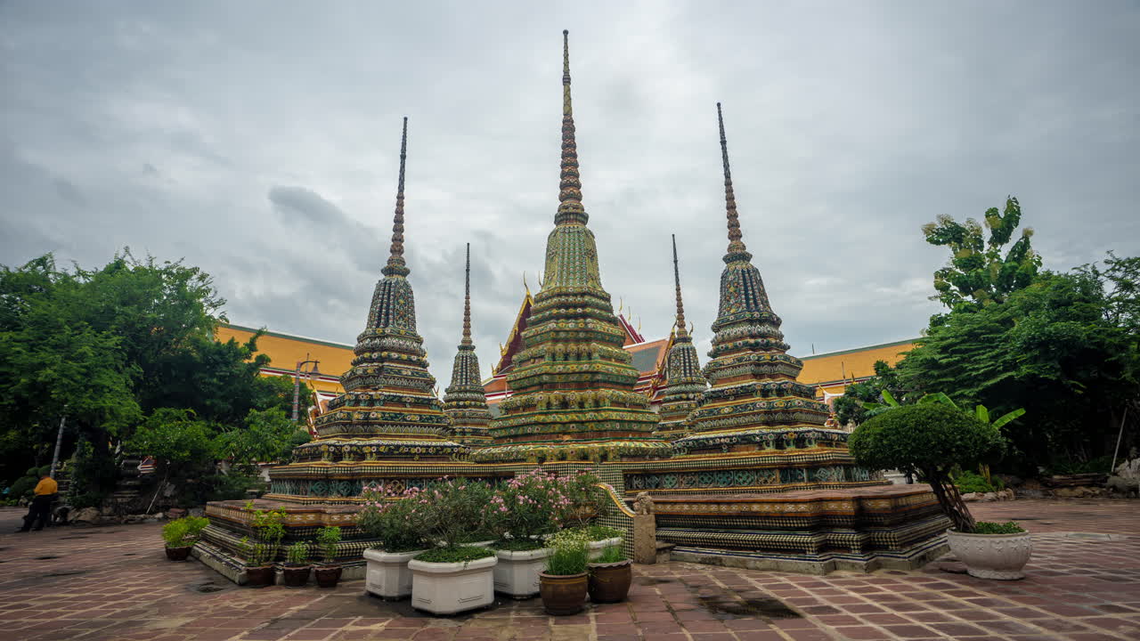 Timelapse of Clouds and Peole Walking Around Buddhist Stupas in Wat Pho Temple Complex, Bangkok Thailand
