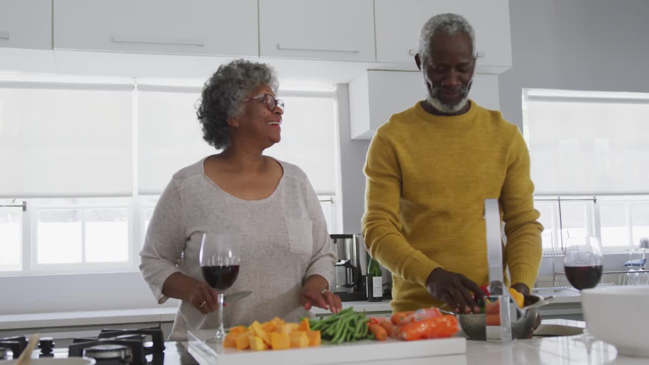 A senior African american couple cooking at home. Social distancing in quarantine