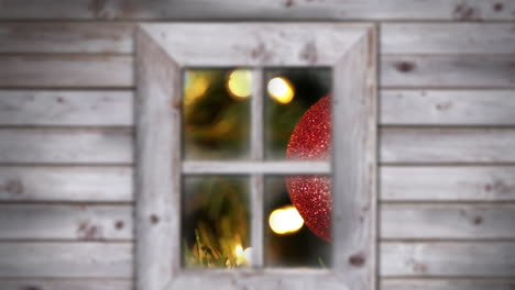 animación de la nieve cayendo sobre el árbol de navidad y la joya roja vista a través de la ventana