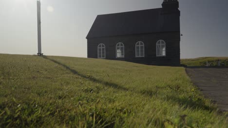 slow motion tilting shot of a the community hvalsneskirkja church in iceland