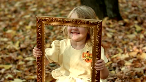 girl posing with picture in autumn park