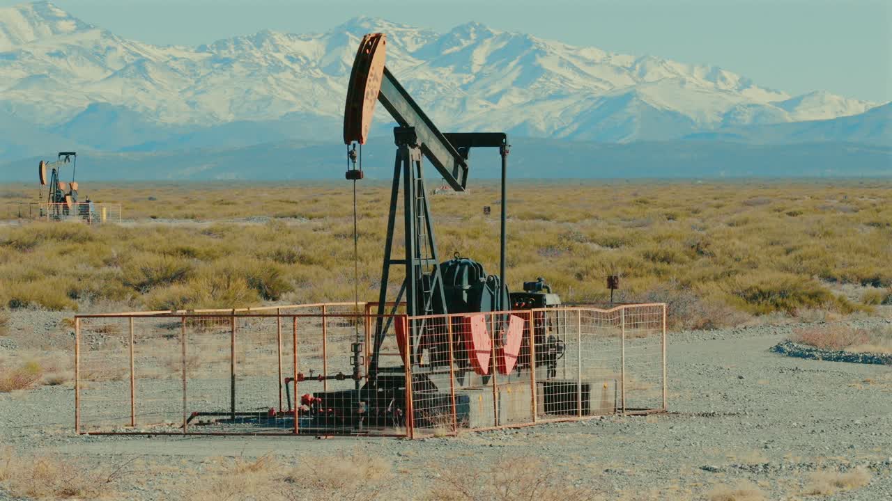 Remote oil field in Argentina overlooking Andes mountain range, oil industry facilities