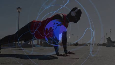 animation of spinning globe against african american fit man performing push up on promenade