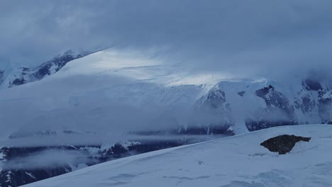 Antarctica-Winter-Mountains-Landscape,-Dramatic-Moody-Blue-Mountain-Scenery-with-Atmospheric-Mood-and-Atmosphere-on-Antarctic-Peninsula,-Snow-and-Ice-Covered-Winter-Icy-Snowy-Mountain-Peaks