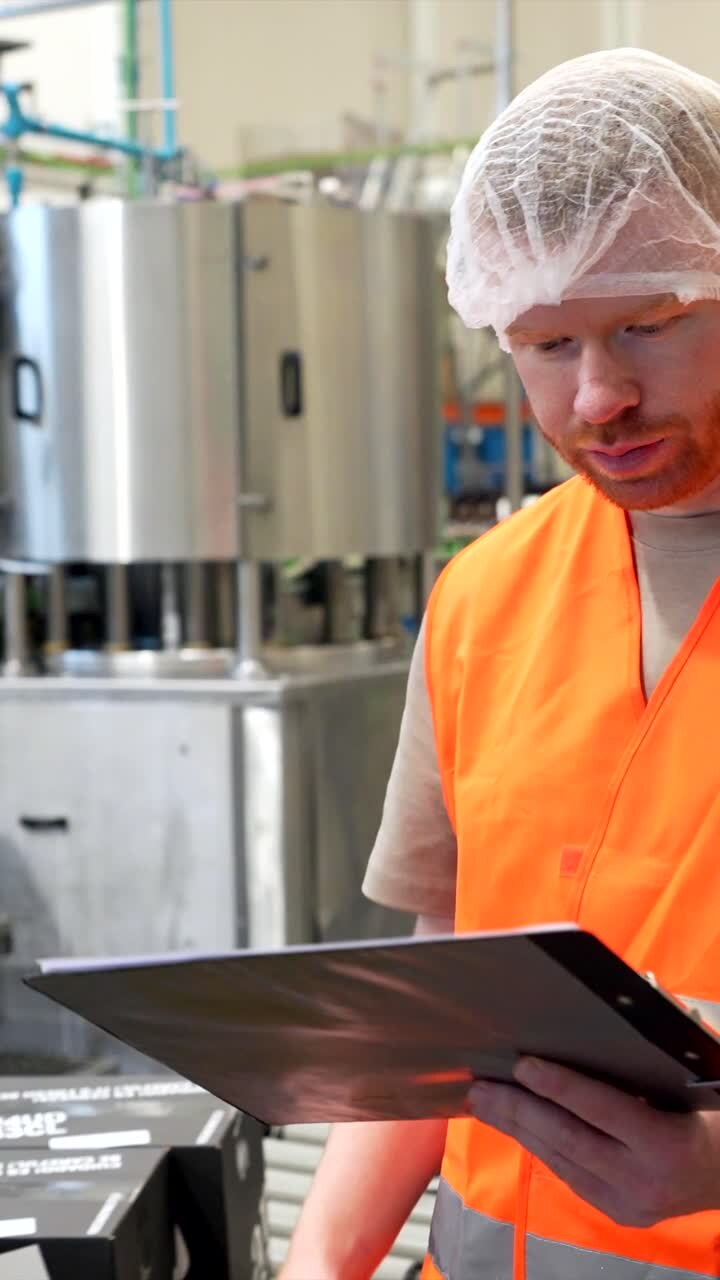 Factory worker inspecting the production line