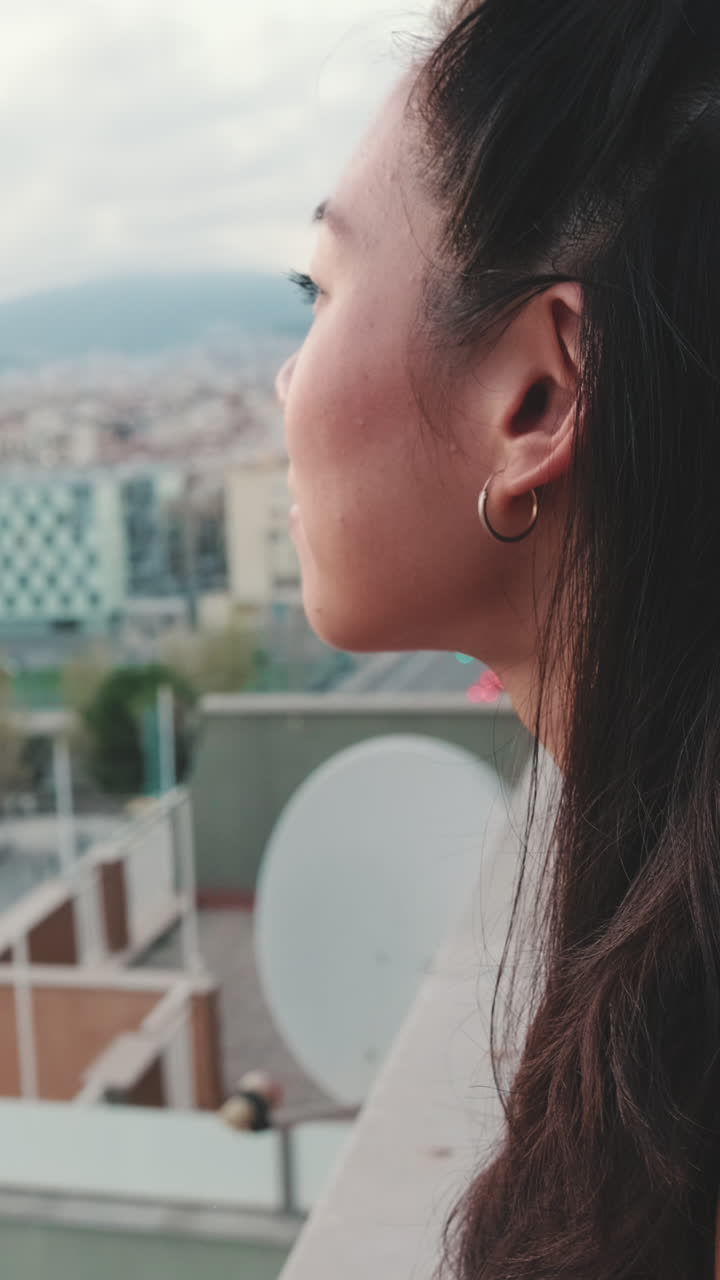 Woman enjoying the city view from a rooftop