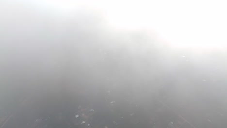 Dolly-in-aerial-view-of-the-beach-town-of-El-Totoral-on-the-central-coast-of-Chile,-covered-by-a-blanket-of-clouds