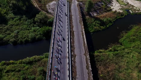 Bicyclist-group-riding-on-bike-ride-at-highway.-Drone-view-cycling-competition