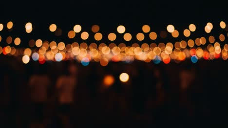 a dreamy night scene: bokeh lights create an enchanting atmosphere with glowing orbs above a gathering, evoking a sense of celebration and togetherness