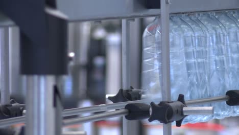 new plastic bottles on the conveyor belt of a drinking water plant