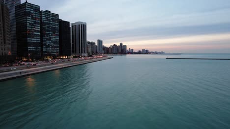 Above-water,-flying-along-Lake-shore-drive-Chicago,-on-Lake-Michigan