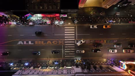 All-Black-Lives-Matter-on-Hollywood-Boulevard-at-nighttime,-ascending-aerial