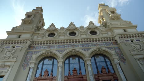 low-angle view of the ornate façade of the monte carlo casino in monaco, showcasing its intricate architectural details, arched windows, and elegant carvings. luxury, heritage, and grandeur.
