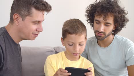 excited boy playing online game on smartphone