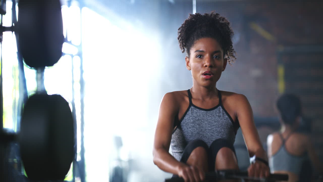 young woman working out on a rowing machine