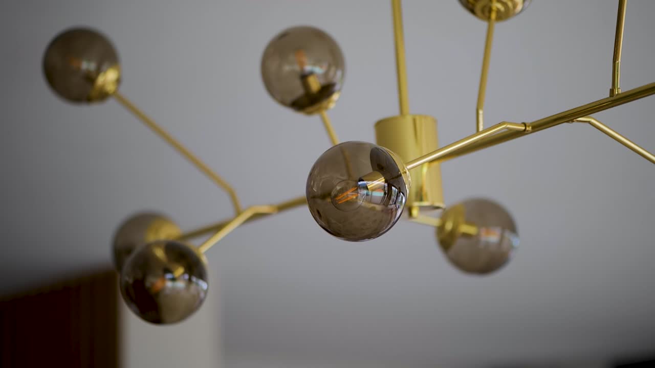 Luxurious Golden Lamp with Round Glass Shades in Modern Interior Design