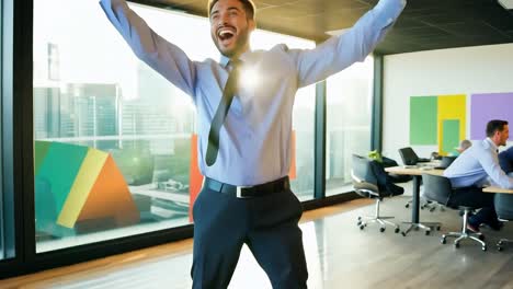 man in business attire celebrates success in office