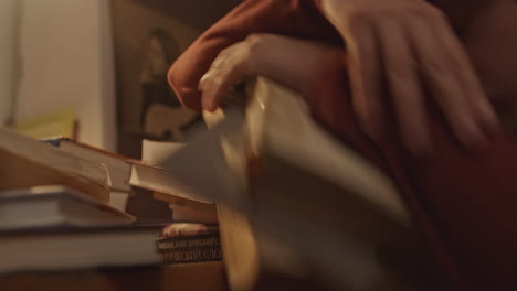 person studying with a pile of books