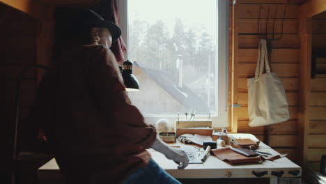 craftsman sitting at desk in workshop